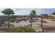 Large kidney shaped pool with a black metal fence at 376 N Iron Horse Dr, Coolidge, AZ 85128