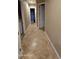 Spacious hallway featuring tile floors and laundry access at 376 N Iron Horse Dr, Coolidge, AZ 85128