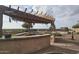 Covered outdoor kitchen area with pergola at 376 N Iron Horse Dr, Coolidge, AZ 85128