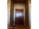 Interior entry with a rich wooden door and tile flooring at 376 N Iron Horse Dr, Coolidge, AZ 85128