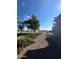Landscaped yard with gravel pathway, mature trees, and shrubs at 376 N Iron Horse Dr, Coolidge, AZ 85128