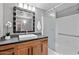 Bathroom with wood vanity, large mirror, and shower/tub combo at 20100 N 78Th Pl # 2179, Scottsdale, AZ 85255