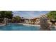 Community pool with lounge chairs and umbrellas at 20100 N 78Th Pl # 2179, Scottsdale, AZ 85255