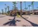 Attractive community entrance with palm trees and flag at 14950 W Mountain View Blvd # 1203, Surprise, AZ 85374