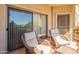 Private patio with wicker chairs, small table, and view at 14950 W Mountain View Blvd # 1203, Surprise, AZ 85374