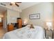 Comfortable bedroom with ceiling fan, dresser, and home office space at 14950 W Mountain View Blvd # 1203, Surprise, AZ 85374