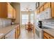 Kitchen boasting light wood cabinets and a view of the dining area at 14950 W Mountain View Blvd # 1203, Surprise, AZ 85374