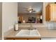 Kitchen features a double sink, updated faucet, and views into the living room at 14950 W Mountain View Blvd # 1203, Surprise, AZ 85374