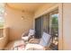 Relaxing patio with wicker chairs and glass door access at 14950 W Mountain View Blvd # 1203, Surprise, AZ 85374