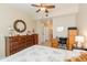 Charming bedroom with ceiling fan, dresser, and a workspace at 14950 W Mountain View Blvd # 1203, Surprise, AZ 85374