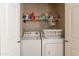 Laundry closet with washer, dryer, and shelving at 14950 W Mountain View Blvd # 1203, Surprise, AZ 85374