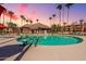 Community pool with surrounding patio furniture at 14950 W Mountain View Blvd # 1203, Surprise, AZ 85374