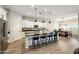 Large kitchen island with seating, granite countertops, and white cabinets at 18172 W Devonshire Ave, Goodyear, AZ 85395