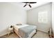 Cozy bedroom with ceiling fan and a window with plantation shutters at 18172 W Devonshire Ave, Goodyear, AZ 85395