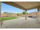 Covered patio with paved area and grassy yard at 18172 W Devonshire Ave, Goodyear, AZ 85395