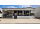 Mobile home exterior with covered deck and seating area at 17200 W Bell Rd # 569, Surprise, AZ 85374