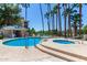 Community pool and spa with palm trees and lounge chairs at 5122 N 31St Way # 227, Phoenix, AZ 85016
