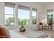 Main bedroom with a view of the backyard and two seating chairs at 7659 E Knoll St, Mesa, AZ 85207