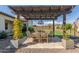 Pergola patio with ornate dining set and landscape at 7659 E Knoll St, Mesa, AZ 85207