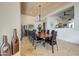 Elegant dining room featuring a large wooden table, black leather chairs, and a stunning chandelier at 10622 E Tamarisk Way, Scottsdale, AZ 85262