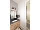 Stylish bathroom with light wood vanity, gray countertop, and black accents at 18206 W San Miguel Ct, Litchfield Park, AZ 85340