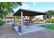 Covered picnic area with tables and trash receptacles at 18206 W San Miguel Ct, Litchfield Park, AZ 85340