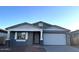 Gray exterior of a single-story house with a two-car garage and landscaping at 7617 W Smoketree Dr, Peoria, AZ 85383