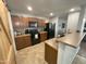 Modern kitchen with dark wood cabinets and granite countertops at 1244 E Desert Rose Trl, San Tan Valley, AZ 85143