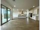 Open concept kitchen and dining area with tile floors and white cabinets at 22730 E Roundup Way, Queen Creek, AZ 85142