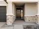 Front entrance with a wooden door and stone accents at 2585 E San Miguel Dr, Casa Grande, AZ 85194