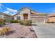 Single-story home with a two car garage and well maintained landscaping at 29922 N Little Leaf Dr, San Tan Valley, AZ 85143