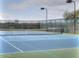 Community tennis court with a net and surrounding fence at 29922 N Little Leaf Dr, San Tan Valley, AZ 85143