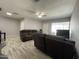Living room featuring two brown sofas, wood-look floors, and a TV at 2941 N 19Th Ave # 84, Phoenix, AZ 85015