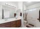 Bathroom with double vanity, a large mirror, and a bathtub at 694 S Mountain View Rd, Apache Junction, AZ 85119