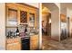 Wet bar with wine rack, granite countertop, and wood cabinetry at 6812 E Monterra Way, Scottsdale, AZ 85266