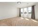 Bright bedroom with neutral carpeting and large windows at 19314 S 208Th Pl, Queen Creek, AZ 85142