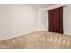 Simple bedroom with dark red curtains and carpeted floor at 19314 S 208Th Pl, Queen Creek, AZ 85142