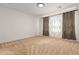 Spacious bedroom with neutral carpeting and large window at 19314 S 208Th Pl, Queen Creek, AZ 85142