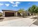 Single-story home with brown garage door and landscaping at 19314 S 208Th Pl, Queen Creek, AZ 85142