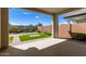 Covered patio overlooking a well-manicured backyard with artificial turf at 19314 S 208Th Pl, Queen Creek, AZ 85142