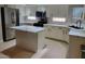 Bright kitchen with white cabinets, quartz countertops, and an island at 427 E Mayfield Dr, San Tan Valley, AZ 85143