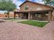 Spacious backyard with covered patio and artificial grass at 427 E Mayfield Dr, San Tan Valley, AZ 85143