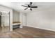 Bedroom with wood-look floors, built-in desk, and mirrored closet at 7625 E Camelback Rd # A418, Scottsdale, AZ 85251