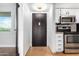 Apartment entryway with dark door and kitchen view at 7625 E Camelback Rd # A418, Scottsdale, AZ 85251