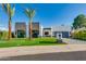 Modern home with clean lines, two palm trees, and a manicured lawn at 8631 E Mariposa Dr, Scottsdale, AZ 85251