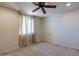 Charming bedroom with ceiling fan and large window at 11040 E Tumbleweed Ave, Mesa, AZ 85212