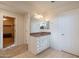 Bathroom features a vanity with sink, and access to a walk-in closet at 11040 E Tumbleweed Ave, Mesa, AZ 85212