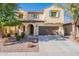 Two-story house with a two-car garage and landscaping at 11040 E Tumbleweed Ave, Mesa, AZ 85212