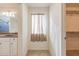 Bathroom boasts a vanity with sink, window with curtains, and an adjacent closet at 11040 E Tumbleweed Ave, Mesa, AZ 85212
