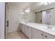 Double vanity bathroom with a large mirror and barn door at 11040 E Tumbleweed Ave, Mesa, AZ 85212
